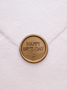 Gold Happy Birthday wax seal on white handmade paper envelope