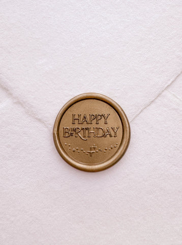 Gold Happy Birthday wax seal on white handmade paper envelope