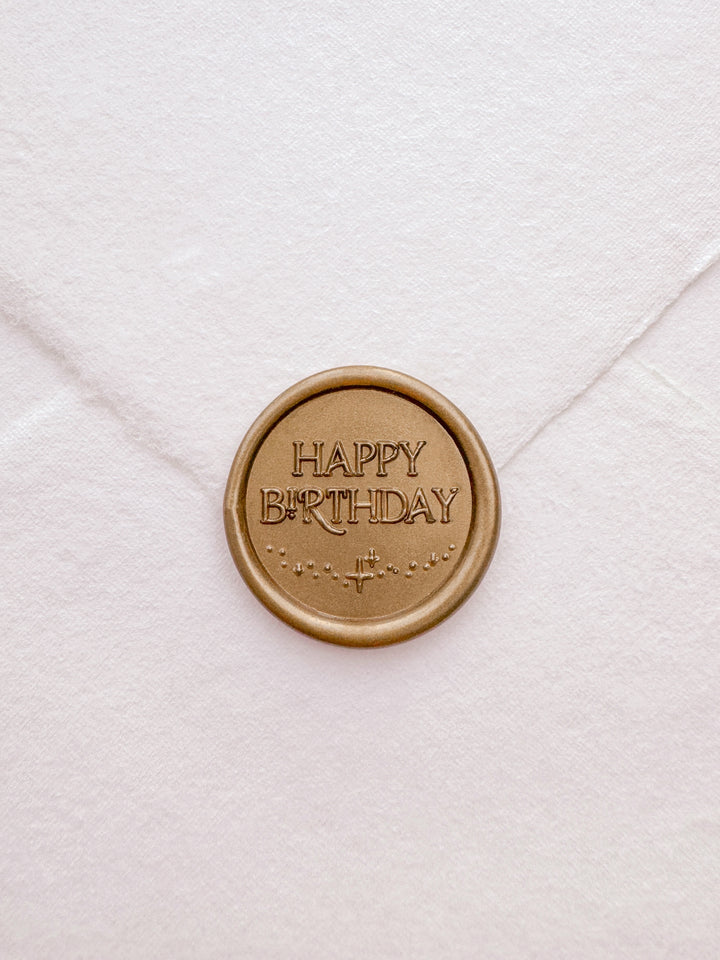 Gold Happy Birthday wax seal on a white deckled edge handmade paper envelope