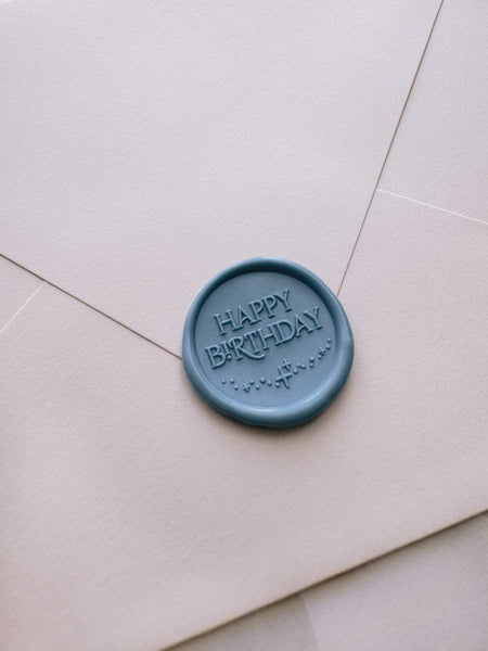 Dusty blue Happy Birthday wax seal on beige envelope
