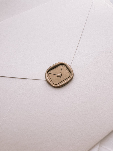 Mini heart sealed envelope gold wax seal on beige envelope