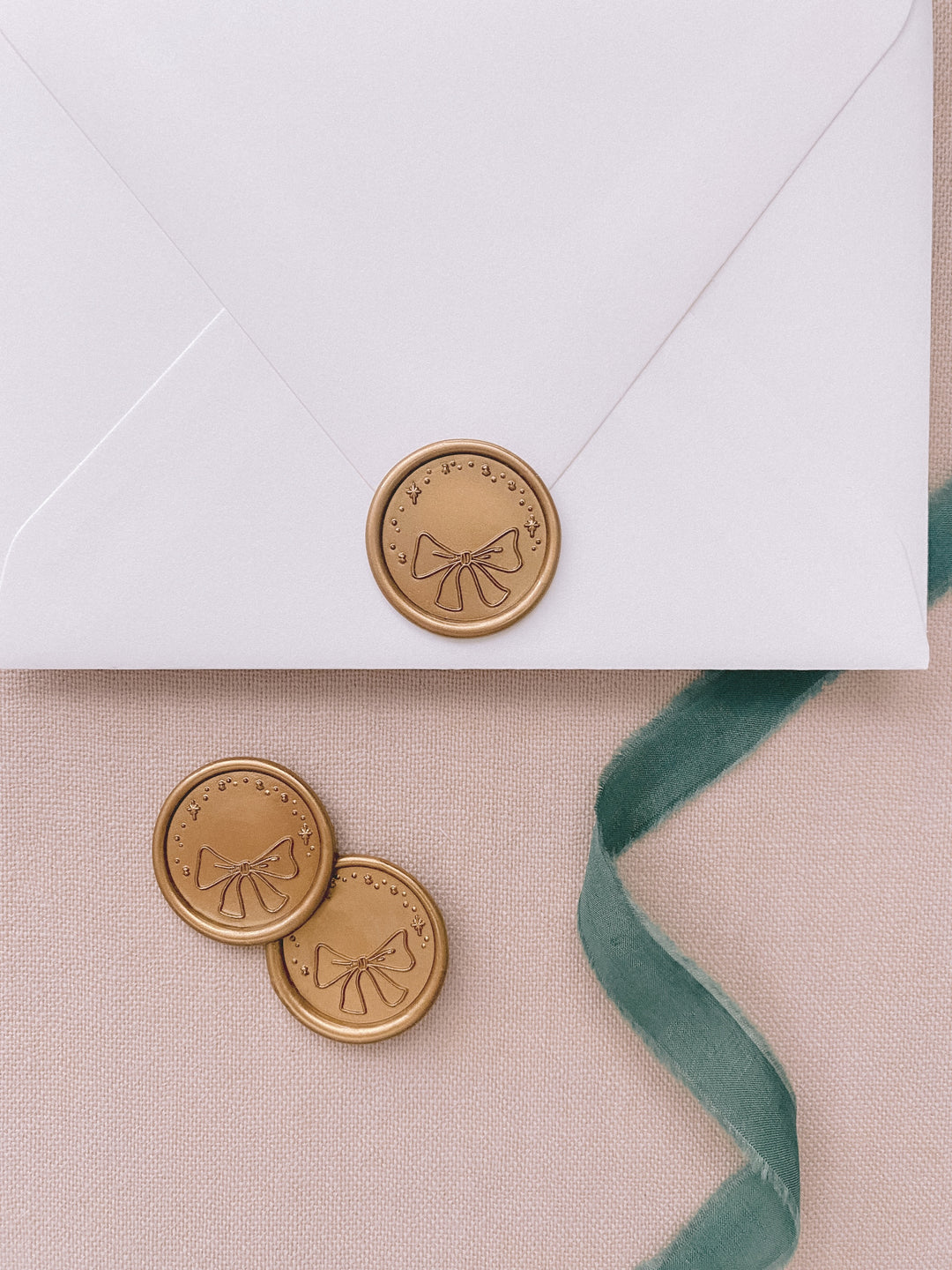 Christmas ribbon gold wax seals on white envelope
