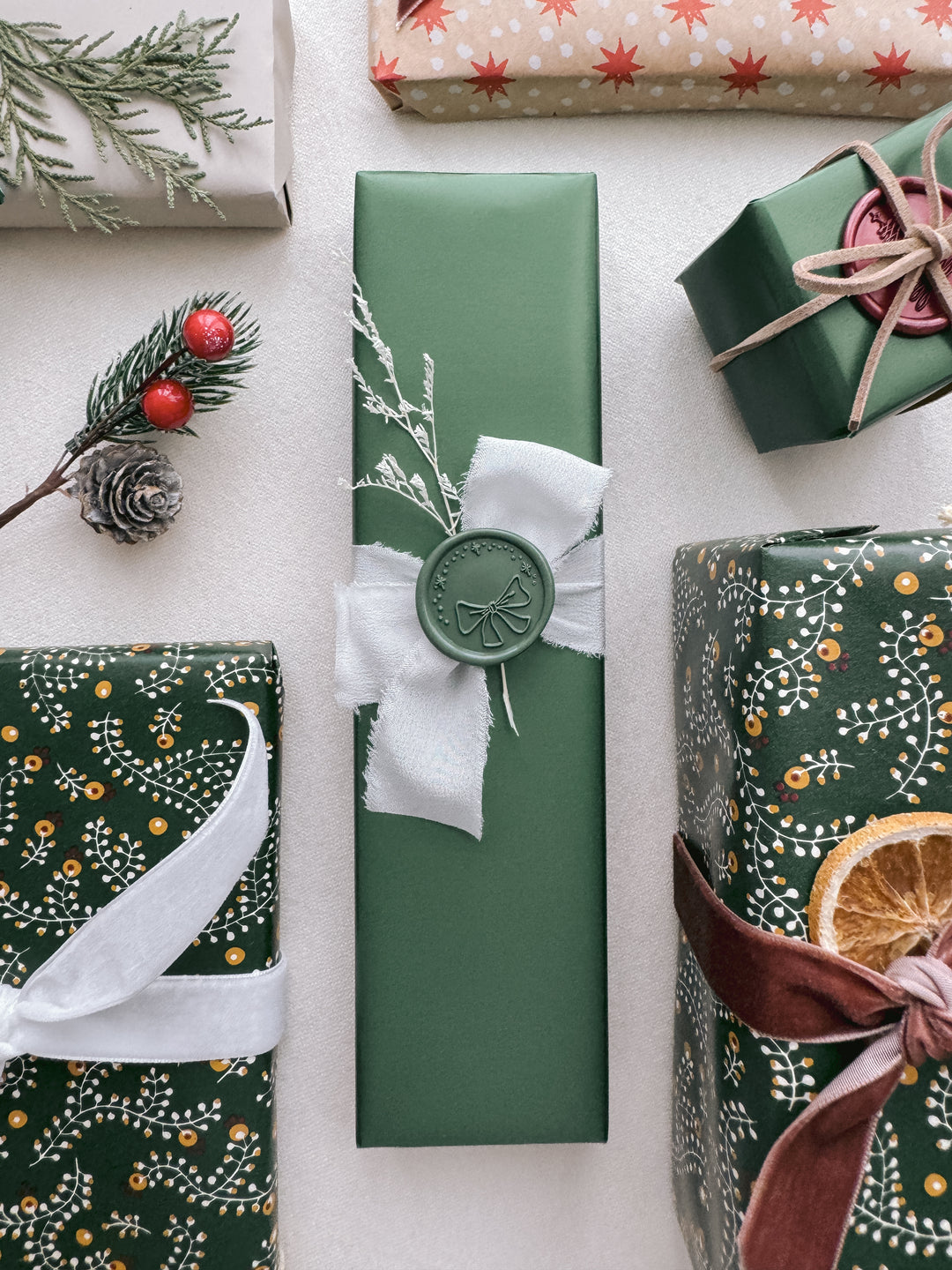 green christmas ribbon bow wax seal on Christmas gift wrap
