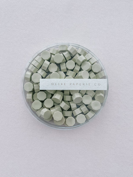 light green sealing wax beads in a clear container box