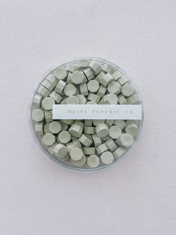 light green sealing wax beads in a clear container box