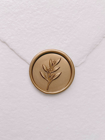 Gold 3D leaf branch wax seal on white handmade paper envelope