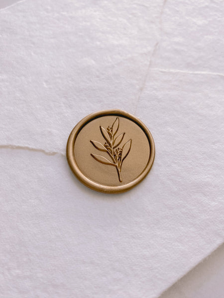 Leaf branch wax seal in gold on handmade paper envelope_side angle
