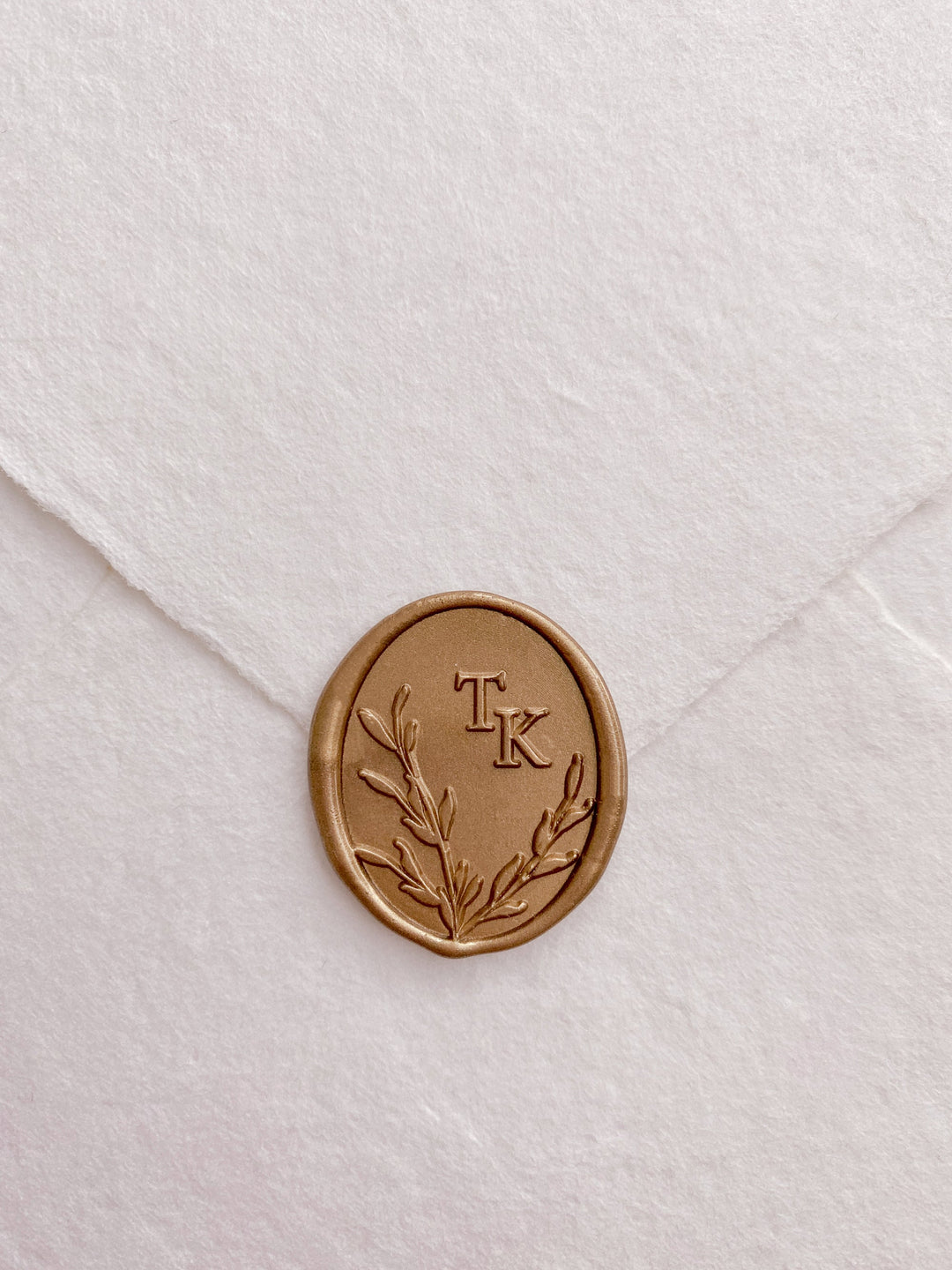 Leaves wreath monogram oval custom wax seals in gold on beige handmade paper envelope