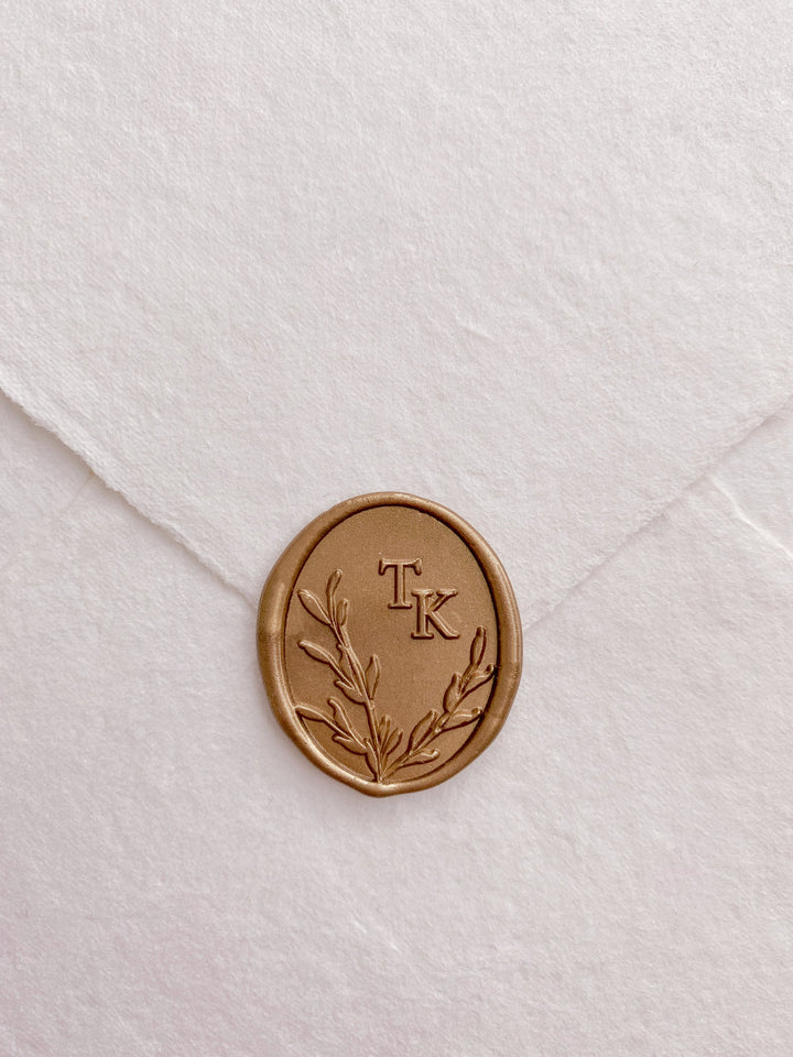 Leaves wreath monogram oval custom wax seals in gold on beige handmade paper envelope
