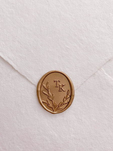 Leaves wreath monogram oval custom wax seals in gold on beige handmade paper envelope 