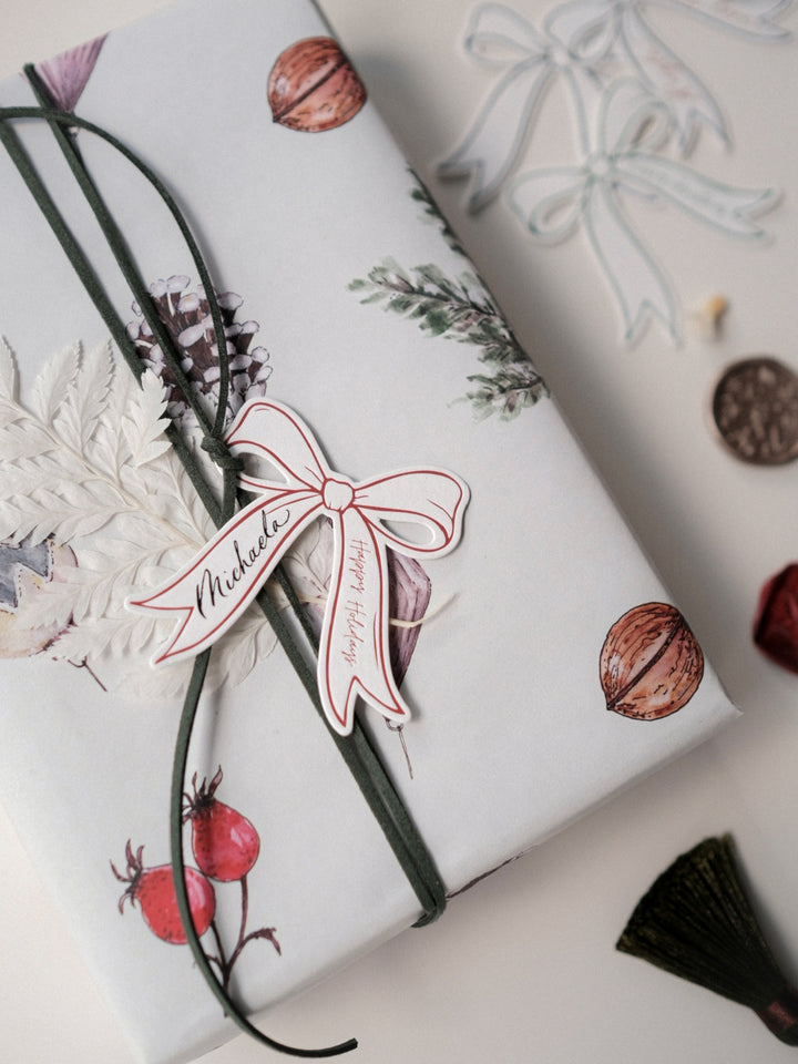Die-cut bow red gift tag on a wrapped Christmas present
