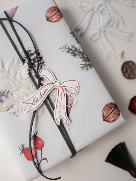 Die-cut bow red gift tag on a wrapped Christmas present