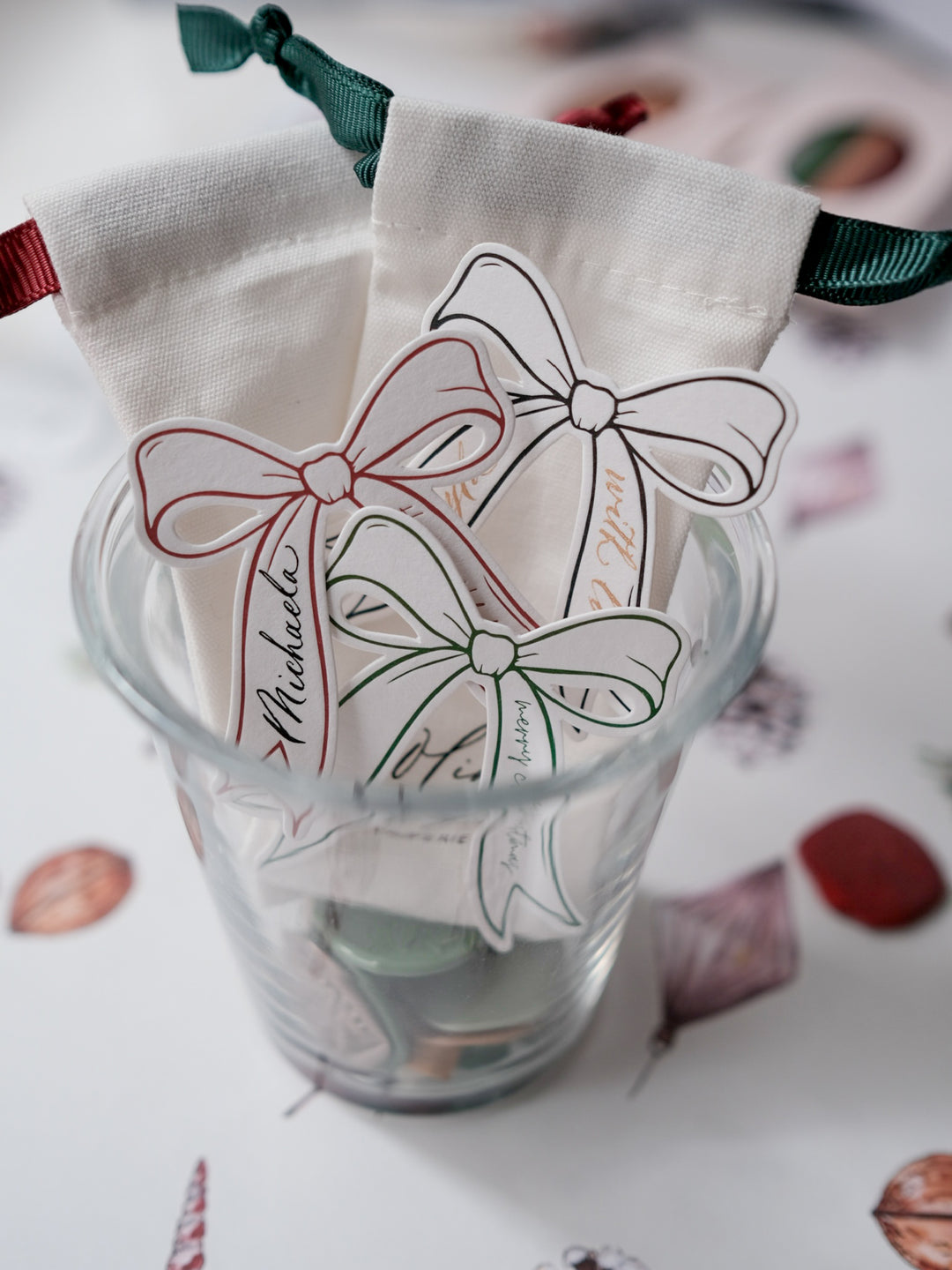 Decorative die-cut bow gift tags in green, red and black with text Merry Christmas and Happy Holidays 