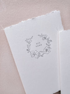 A set of two His and Her letterpress floral wreath vow books with fine white twine