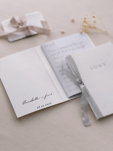 white vow books personalized with couple's names and wedding date