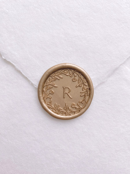 floral edge design single initial wax seal in light gold color on white handmade paper envelope_front angle
