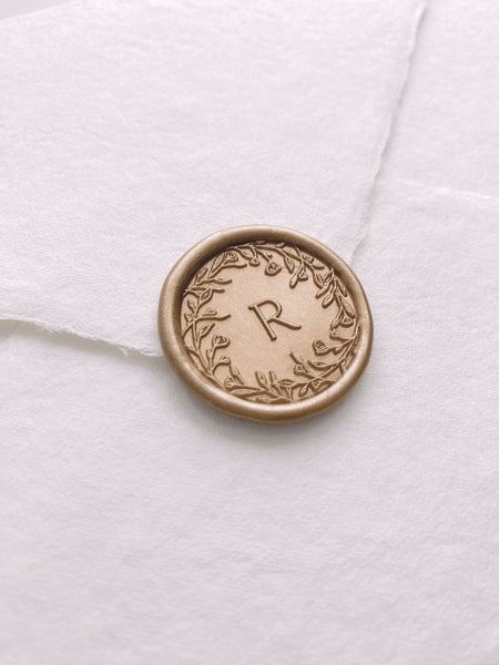 floral edge design single initial wax seal in light gold color on beige handmade paper envelope