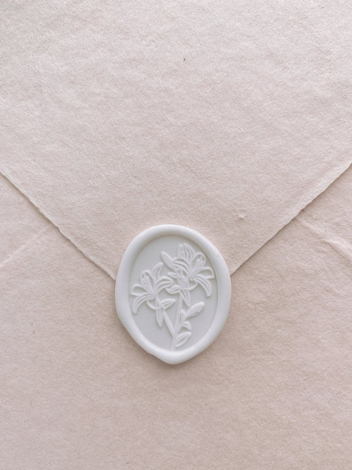 Oval lily floral white wax seal on handmade paper envelope