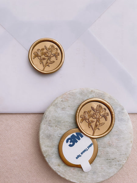 Lily round wax seals in gold with 3m sticker on small gray stone dish