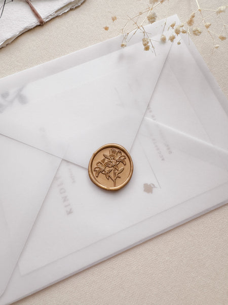 Lilies floral gold wax seal on a vellum envelope