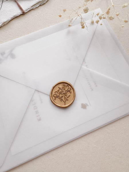 Lilies gold floral wax seal on a vellum envelope