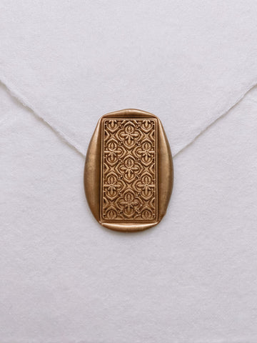 Moroccan tile pattern rectangular wax seal in gold on handmade paper envelope_front angle