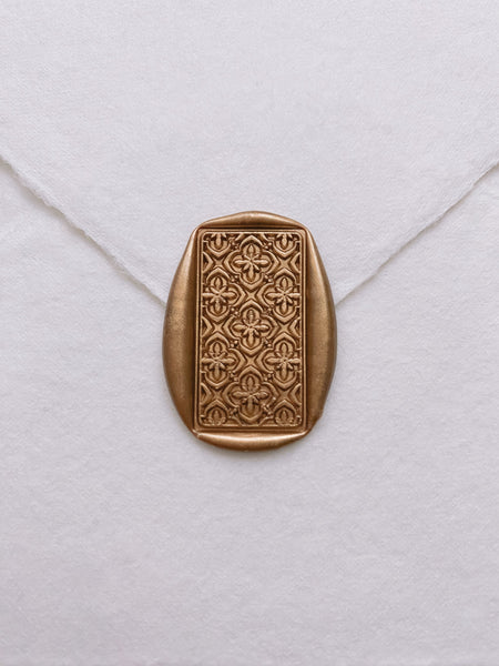 Moroccan tile pattern rectangular wax seal in gold on handmade paper envelope_front angle