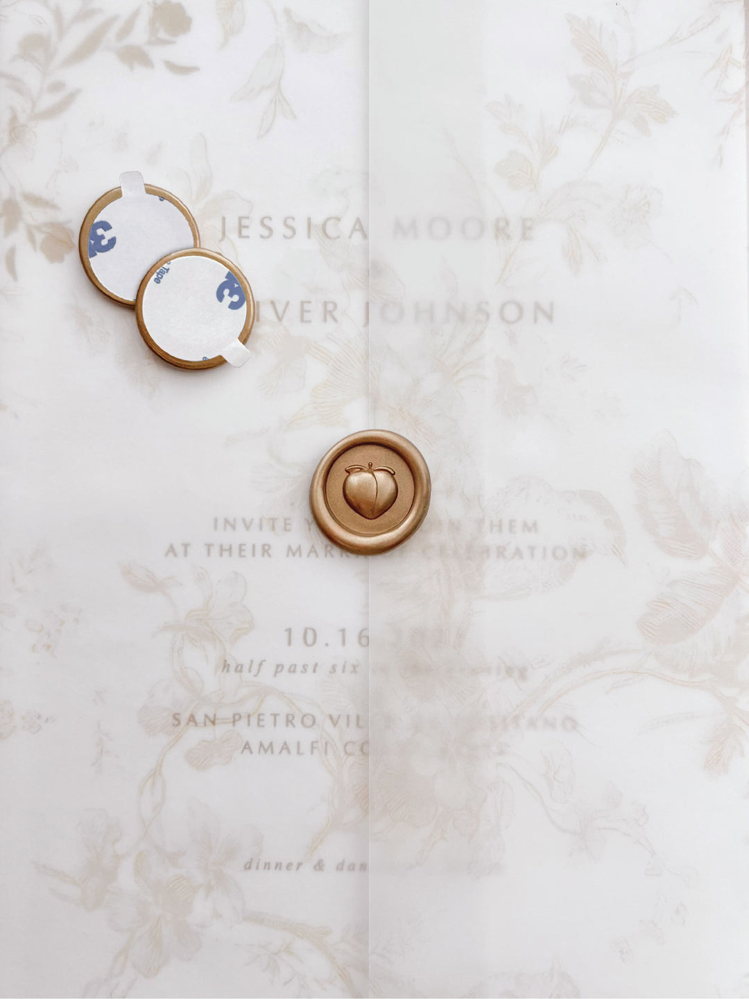 Gold 3D peach mini wax seal stickers with self-adhesive backings on a beige floral vellum jacket