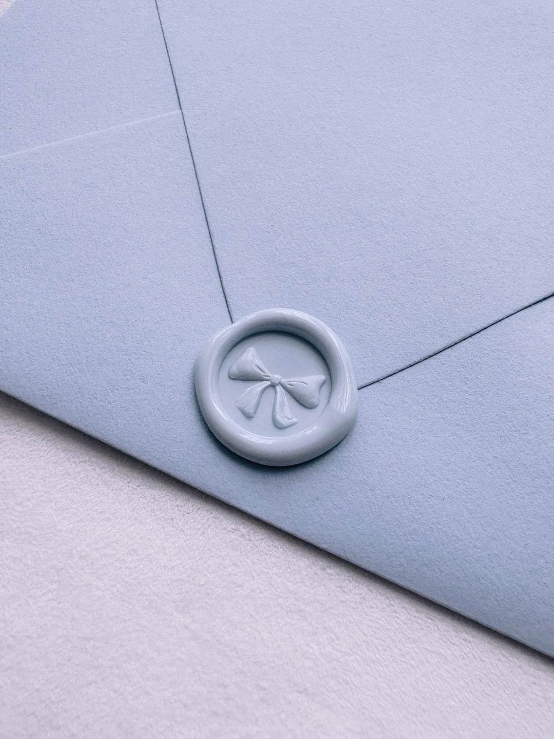 light blue 3D ribbon bow mini wax seal on an envelope