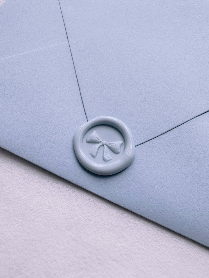 light blue 3D ribbon bow mini wax seal on an envelope
