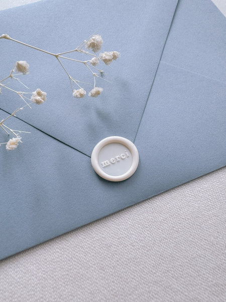 Off-white mini thank you wax seal featuring the word merci