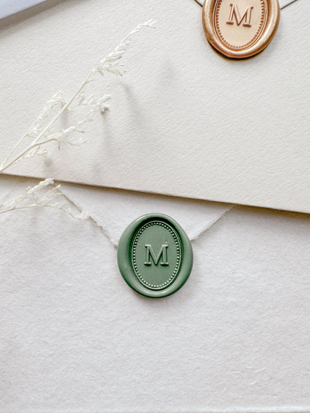 Green mini oval custom monogram wax seal with a border design