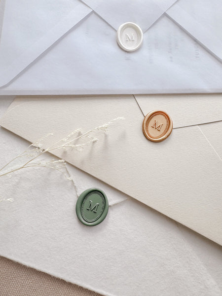 Mini oval custom initial wax seals in color white pearl, peachy gold, and sage green