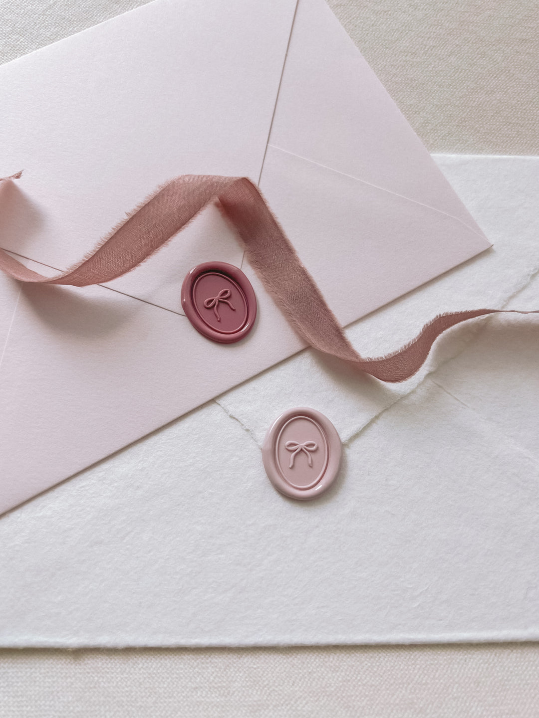 hand-drawn bow mini oval wax seals in dusty rose and light pink