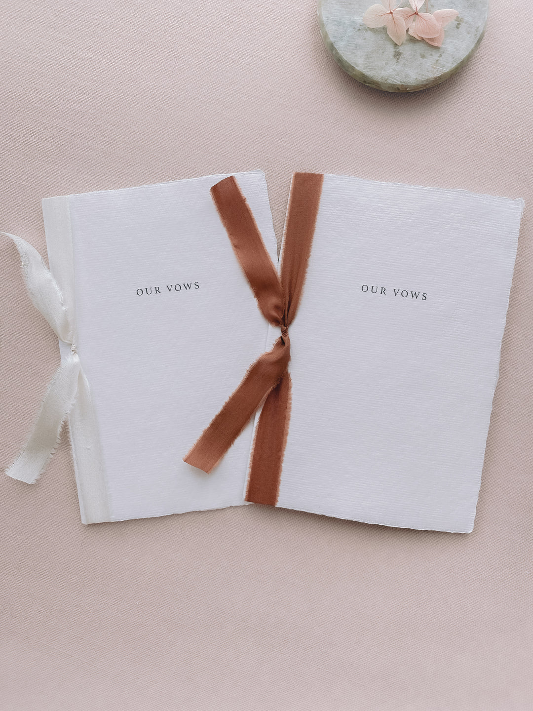 Our vows white wedding vow books tied in cinnamon brown colored and white silk ribbon