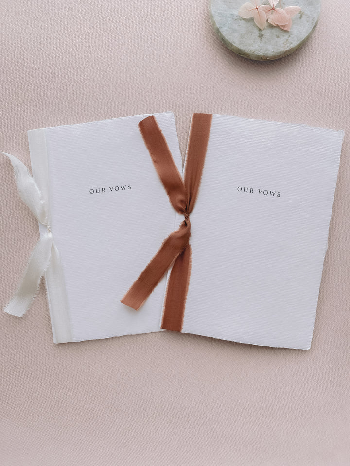 Our vows white wedding vow books tied in cinnamon brown colored and white silk ribbon