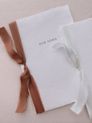 Our vows white handmade paper vow books tied in cinnamon brown colored and white silk ribbon