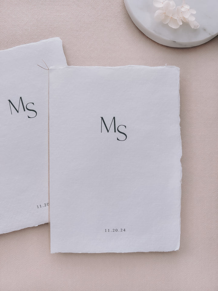 custom monogram white handmade paper wedding vow books tied in brown twine