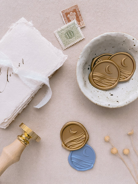 3D moon and ocean wax seals in gold and dusty blue