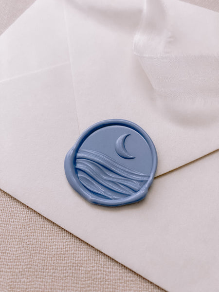 3D moon and ocean dusty blue wax seal on paper envelope