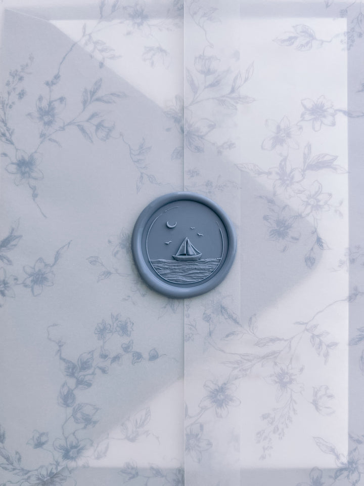 Dusty blue 3D sailboat coastal wax seal on a translucent blue floral print vellum jacket