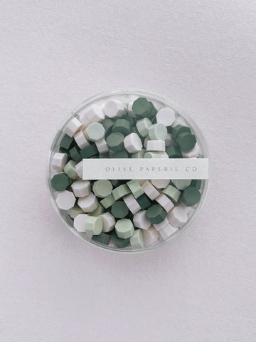 Assorted mix of pine green, light green and white sealing wax beads in a clear container box