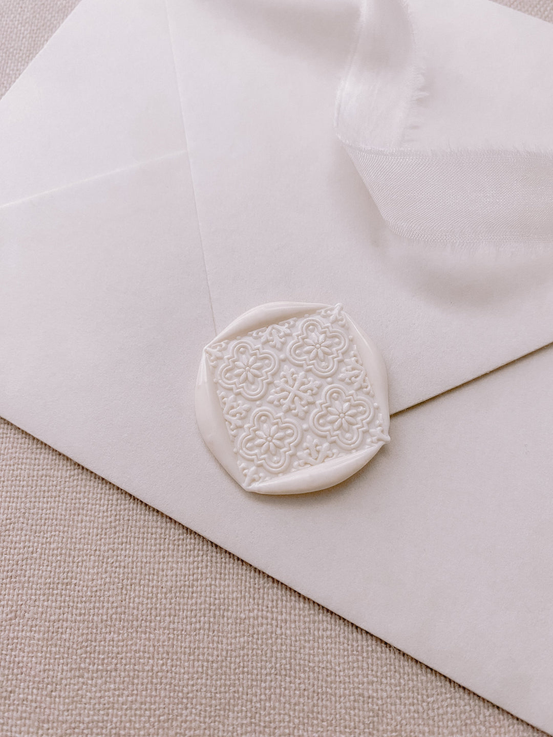 Moroccan tile pattern diamond shaped wax seal in off white on paper envelope_side angle