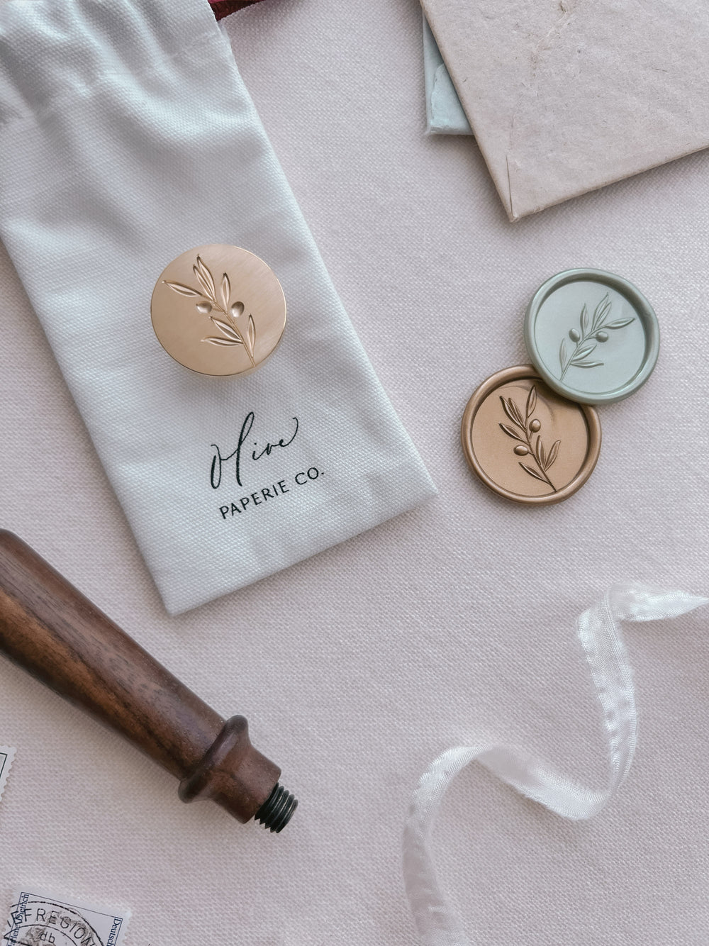 Olive branch brass wax stamp head with gold and light metallic green olive branch wax seals with a walnut wood handle 