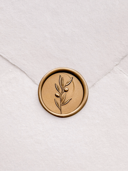 Olive branch design gold wax seal with 3D engraving details on a white envelope