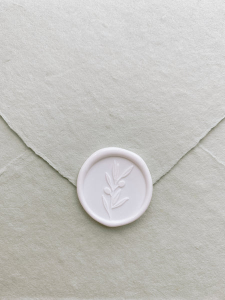 Olive branch wax seal in white on light olive handmade paper envelope