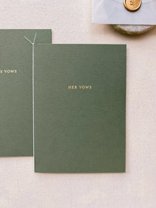 A set of two His and Her gold foil olive green card stock vow books in typeface font with fine white twine