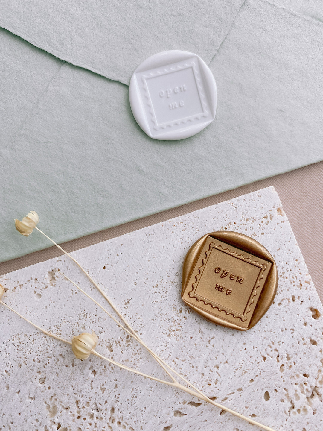 Open Me square shaped wax seals in white on handmade paper envelope and open me square shaped gold wax seal