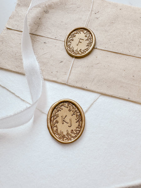 oval floral wreath monogram gold wax seals on handmade paper envelopes