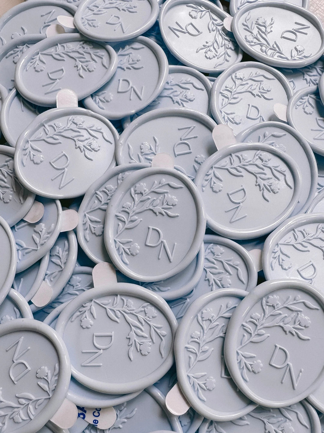 Oval floral silhouette monogram wax seal sickers with adhesive backings in color pale blue